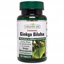 Close-up image of green leaves surrounding a bottle of Natures Aid Ginkgo Biloba tablets.